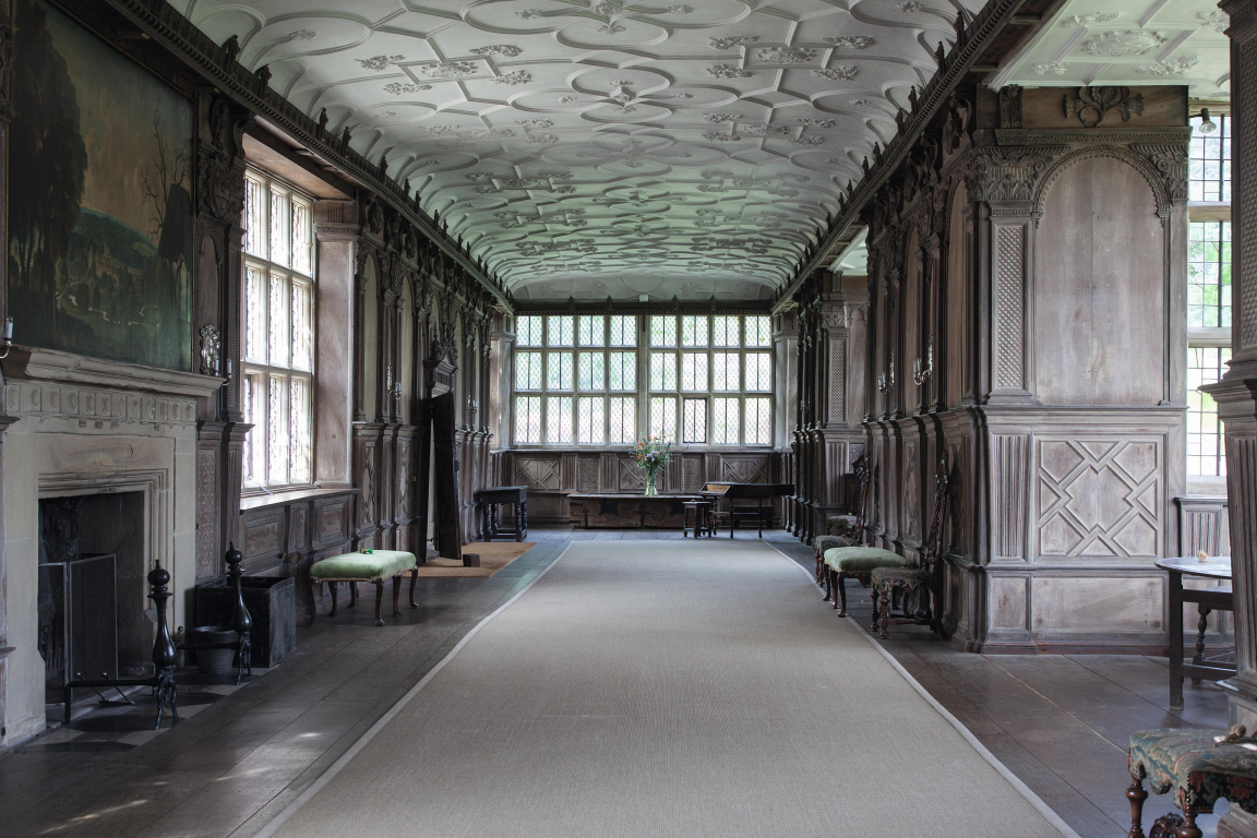 Haddon Hall.  The Long Gallery. A union of natural surfaces; wood, stone and plaster with no colour, creating a dry beauty. Rex Whistler’s painting, a romantic vision of the house in its landscape is on the left above the fireplace.