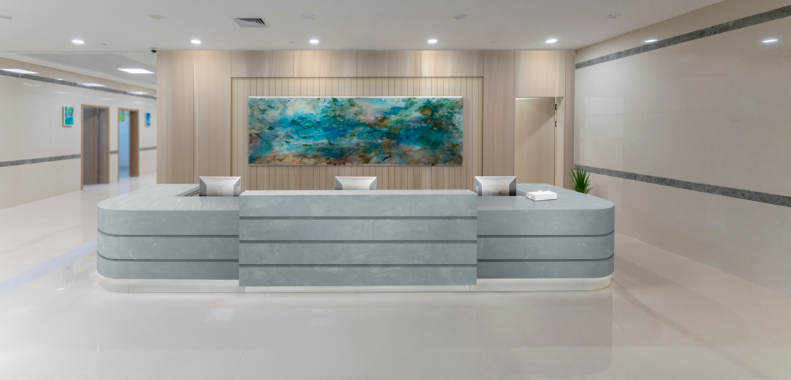 Corian® Artista Mist and Corian® Bleached Nuwood Reception Desk