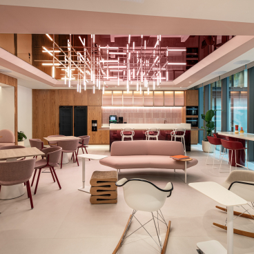 Modern Dubai office space featuring vibrant colors, contemporary furniture, and natural light, creating an inspiring workplace environment.