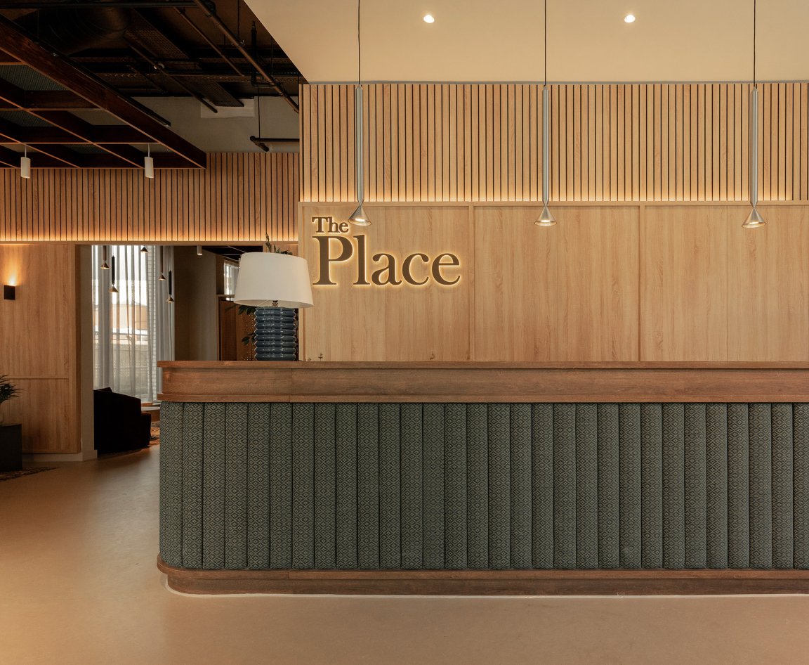 Sophisticated reception area of The Place in Nottingham, featuring wooden accents and elegant lighting design.