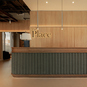 Sophisticated reception area of The Place in Nottingham, featuring wooden accents and elegant lighting design.