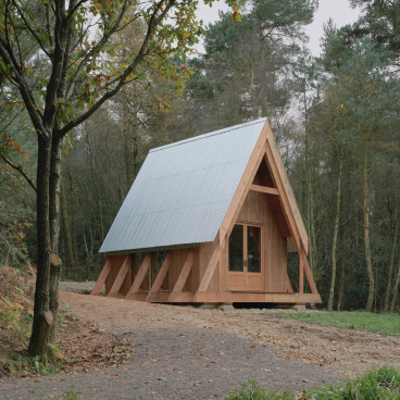 Clearfell House, an innovative timber structure, nestled in a forested landscape showcasing underutilised British timber species.