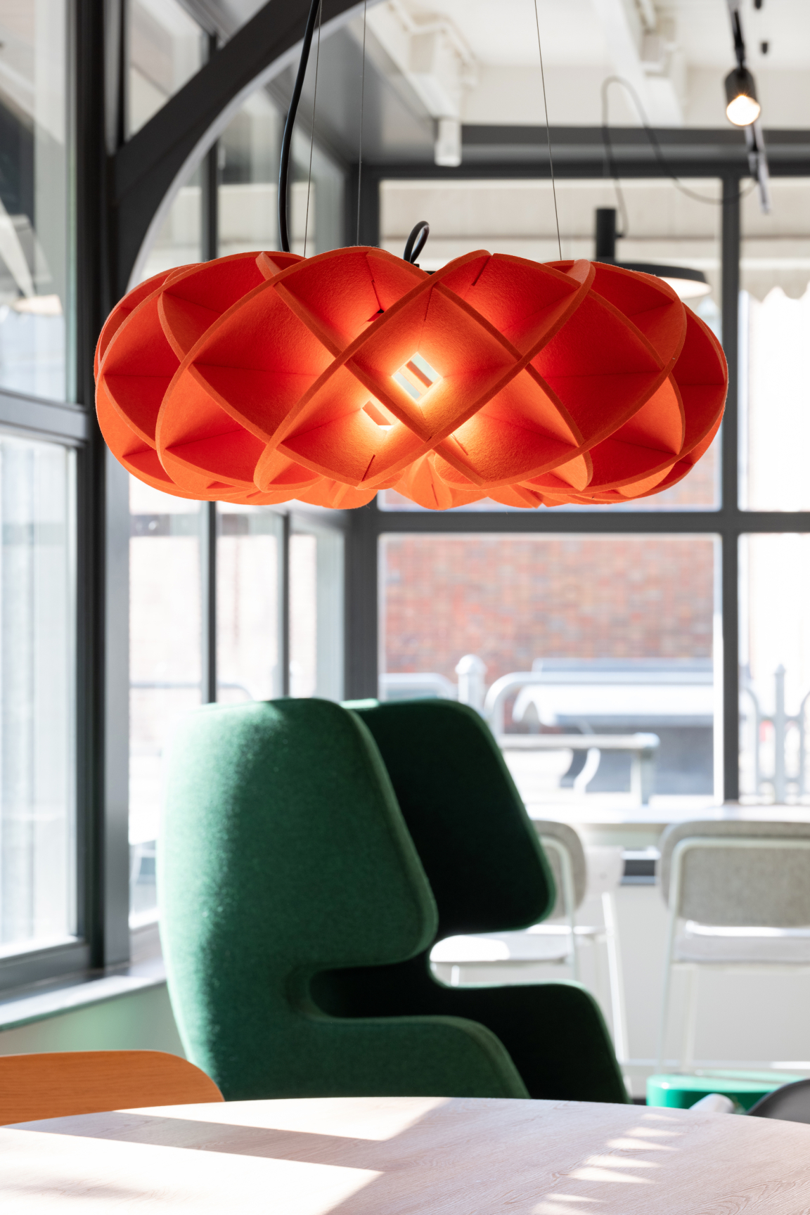 Stylish lumenear acoustic lighting fixture in red, enhancing interior spaces while providing sound absorption and illumination.