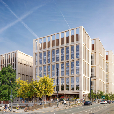 Modern Manchester Digital Campus office complex designed by AtkinsRéalis, featuring green spaces and urban architecture.