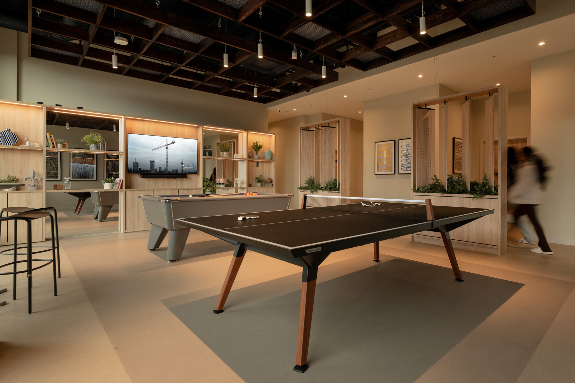 Stylish interior of The Place in Nottingham featuring a game area with a ping pong table and modern furnishings.