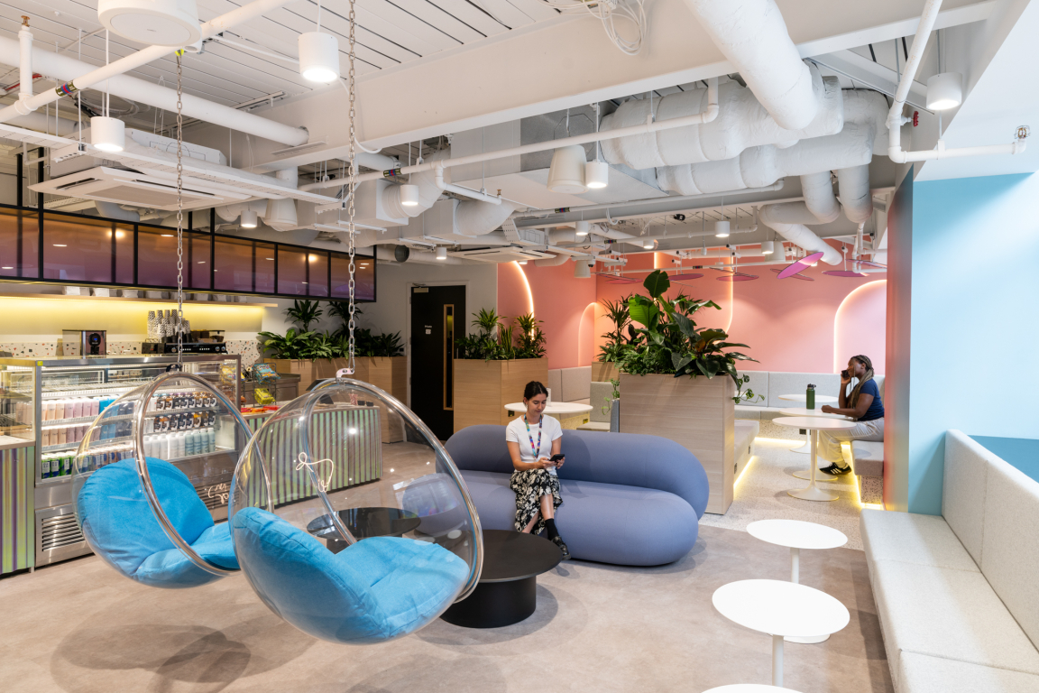 Vibrant coworking space at Huckletree featuring hanging chairs, colorful decor, and cozy seating for collaboration and relaxation.