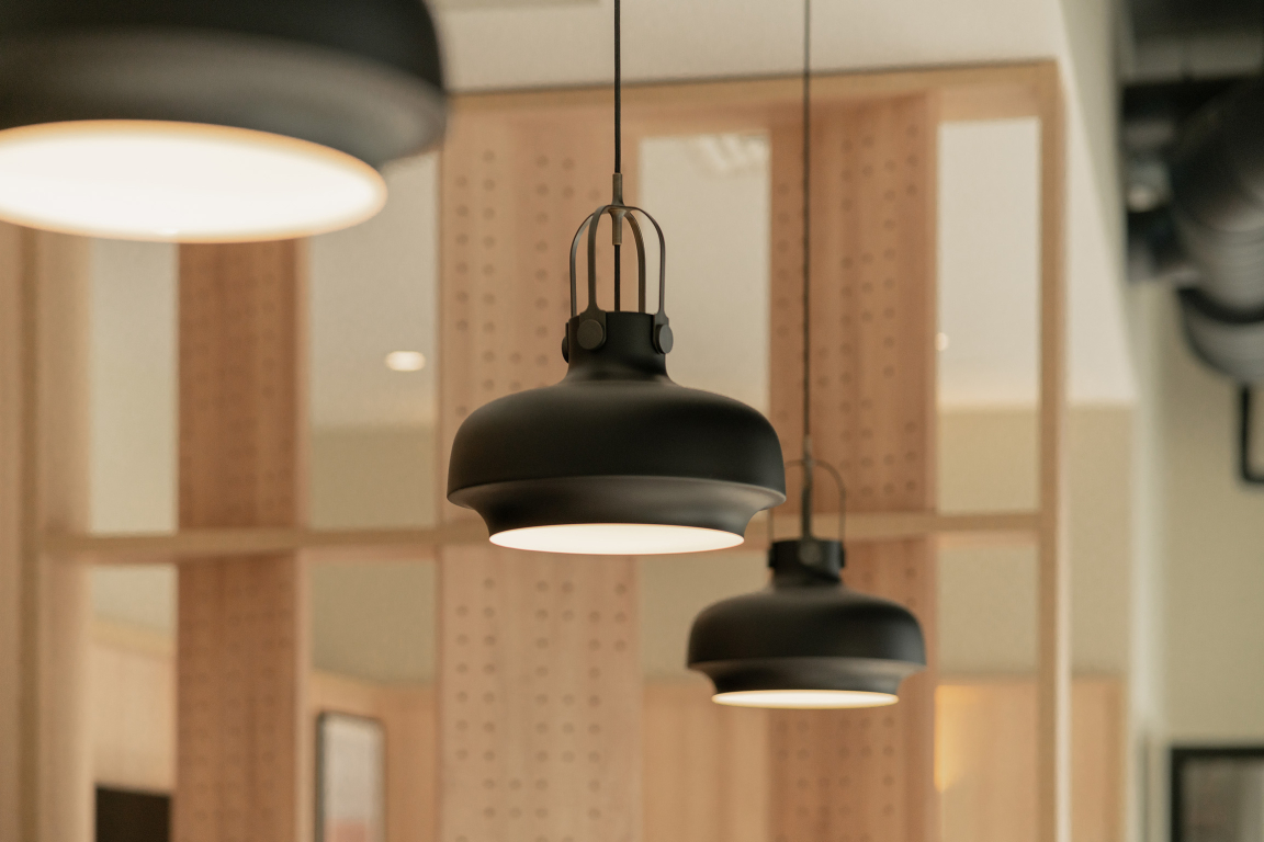 Modern black pendant lights hang elegantly in the sophisticated interior of The Place, Nottingham's new PBSA development.