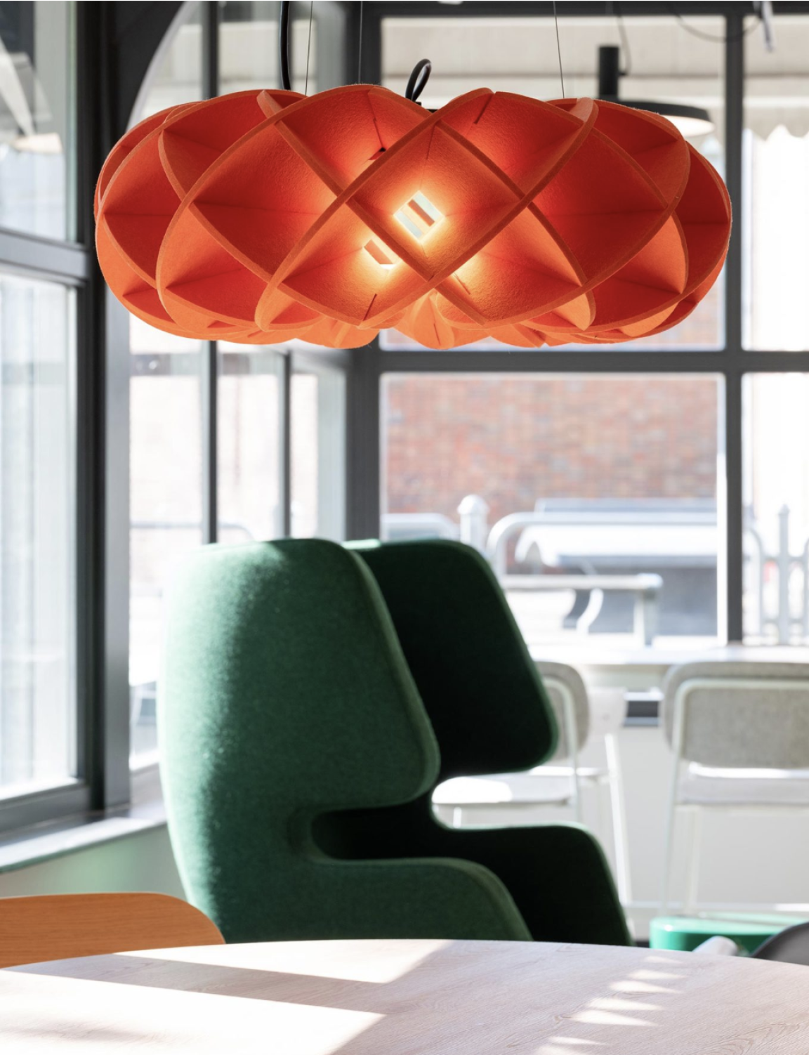 Halo light hangs above table and chairs