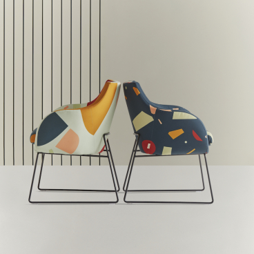 Colorful geometric chairs from Tom Pigeon collection designed by Roger Lewis, showcasing British craftsmanship and playful design.