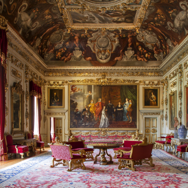 Wilton House. The Double Cube Room; one of the greatest of the great rooms of parade in England. The amount of gilding, the very large Van Dyck portrait of the Pembroke family and the red velvet upholstery are powerful enough to balance the weight of the strong colours of the painted, deep cove and ceiling. Courtesy © Derry Moore | Prestel