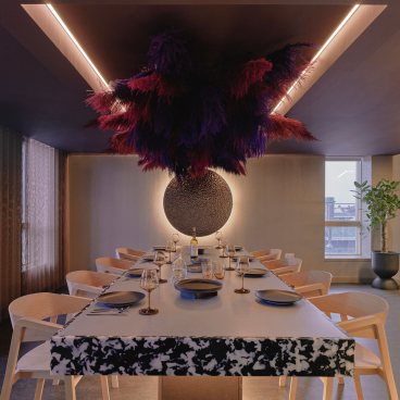 Elegant dining area with artistic decor, featuring a large table, stylish chairs, and unique ceiling design, Edinburgh PBSA.