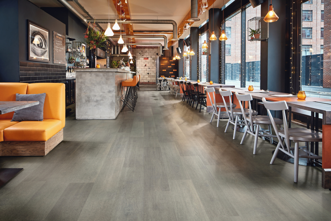 Stylish restaurant interior showcasing Karndean's new natural oak flooring design in a contemporary setting.