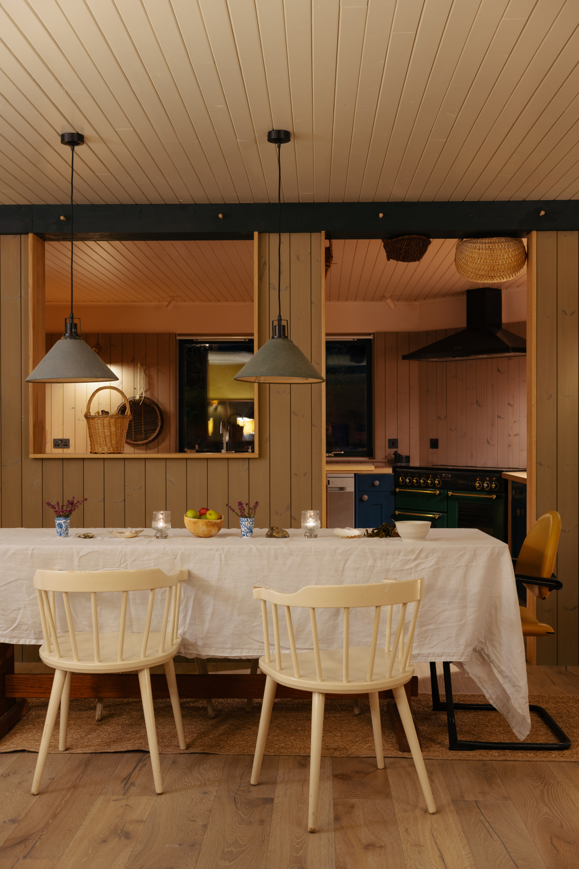 Light-filled dining area showcasing a blend of Hebridean and Scandinavian design with wooden elements and simple decor.