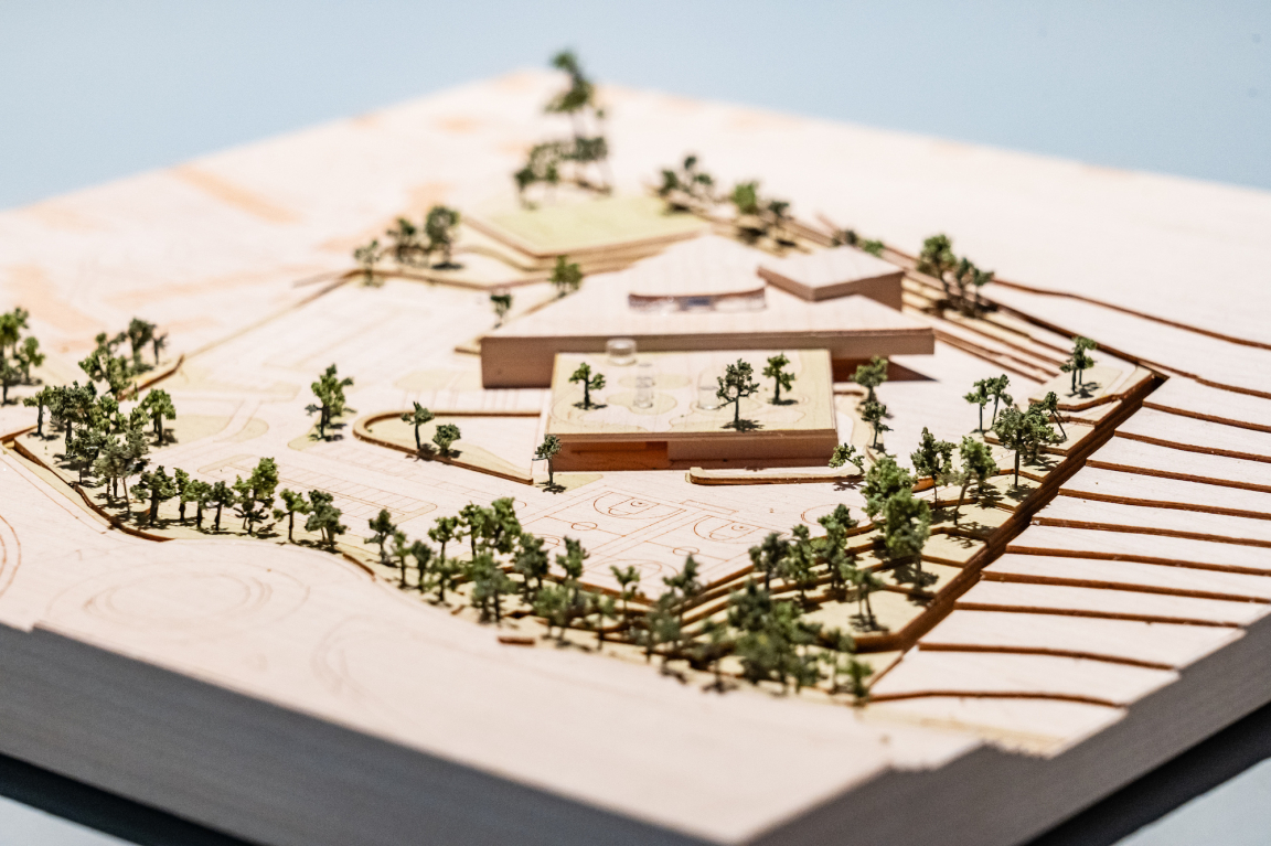 Architectural model showcasing a landscaped design with buildings and greenery, illustrating BDP Glasgow's creative vision.