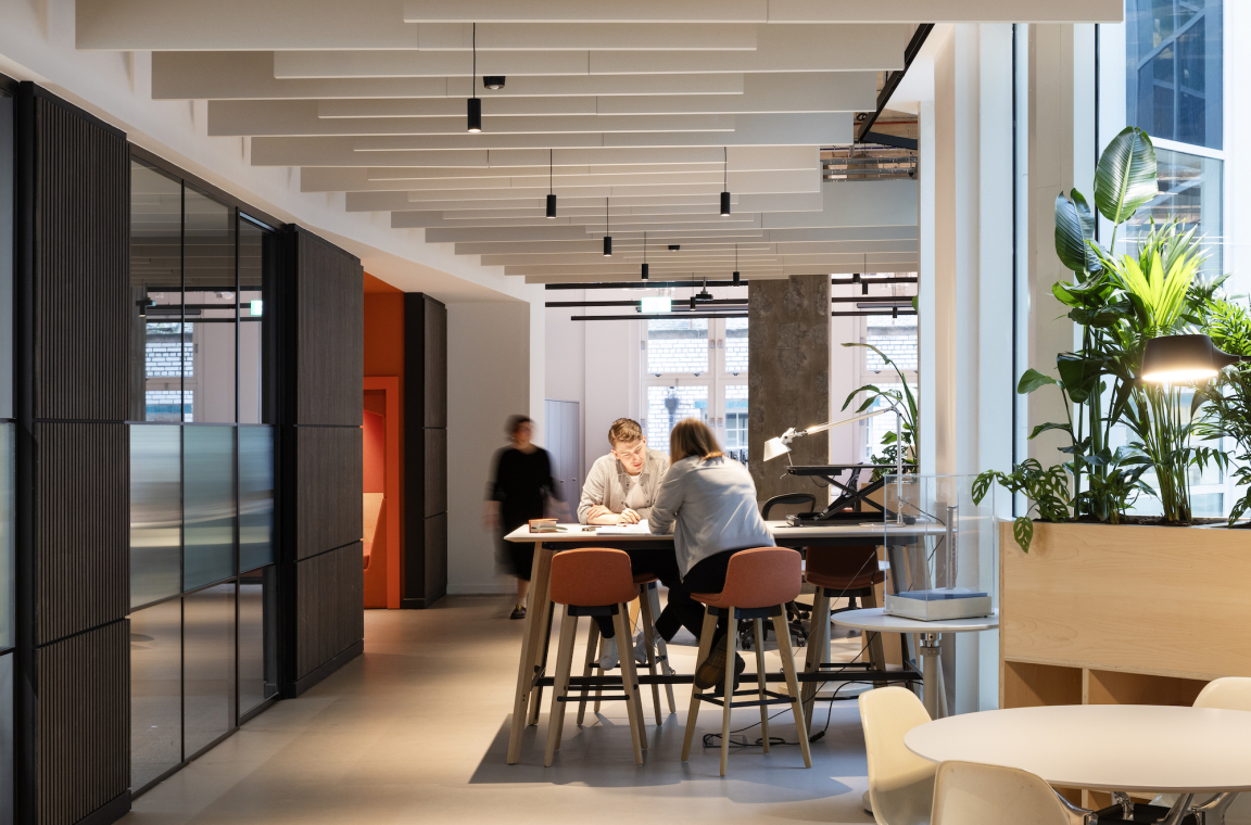 Modern workspace at BDP Glasgow studio, featuring collaborative areas, plant decor, and natural lighting in the Grosvenor Building.