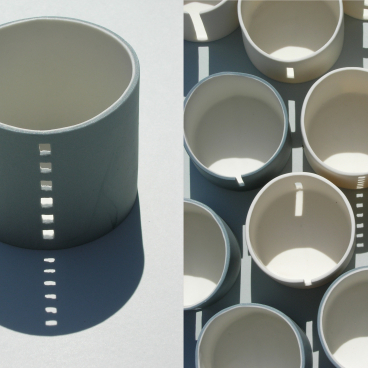 Ceramic vessels by Jo Woffinden casting intricate shadows, showcasing contemporary craft at the Harewood House Biennial.