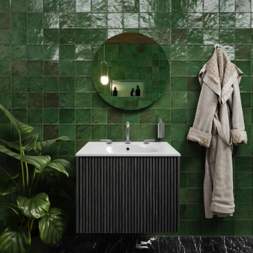 Stylish bathroom featuring green tiled walls, modern vanity, round mirror, and plant, showcasing playful nostalgia and Japanese Nouveau aesthetics.