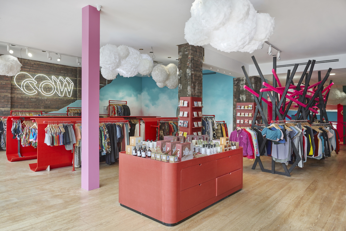 Vibrant interior of COW's flagship vintage store in Leeds, featuring colorful clothing racks and unique decor elements.