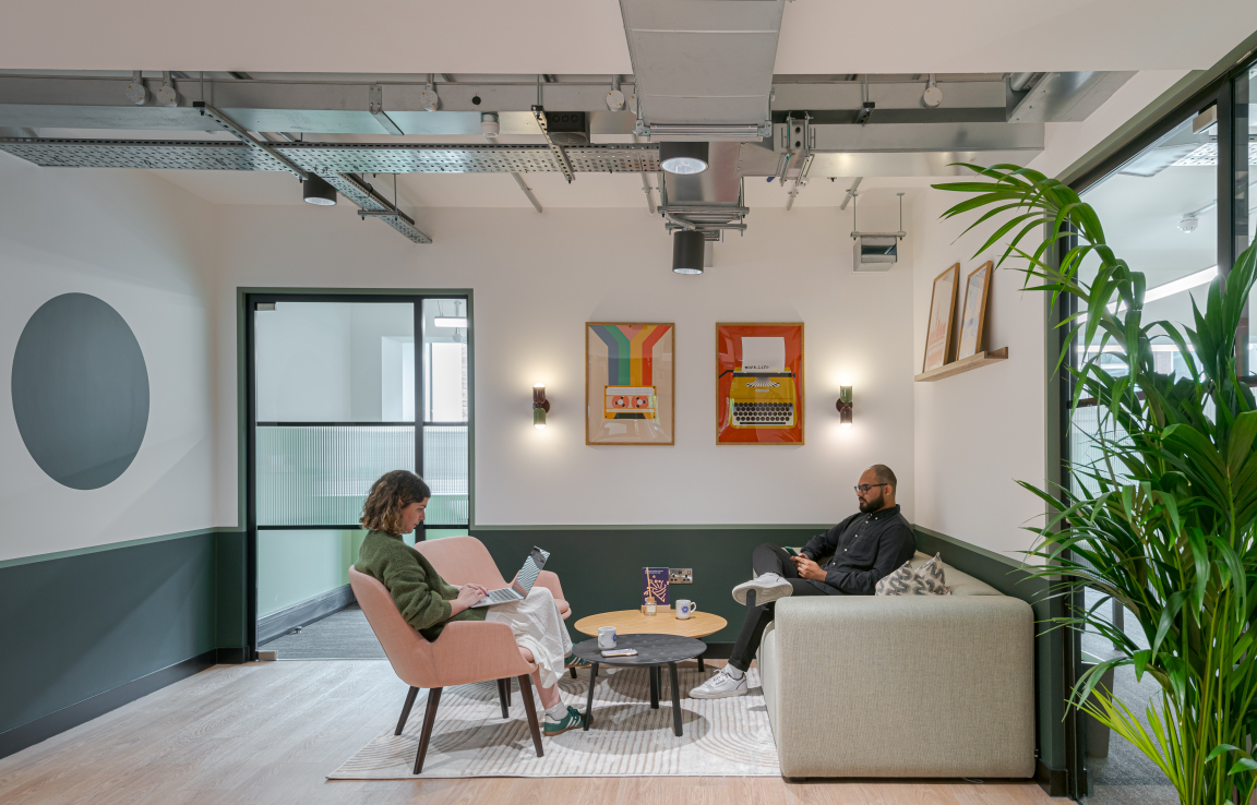 Contemporary co-working space in The Typewriter building with stylish seating, artwork, and natural lighting promoting productivity.