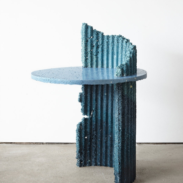 Sustainable design piece featuring a unique blue table made from recycled materials, reflecting ecological innovation at London Design Festival 2018.