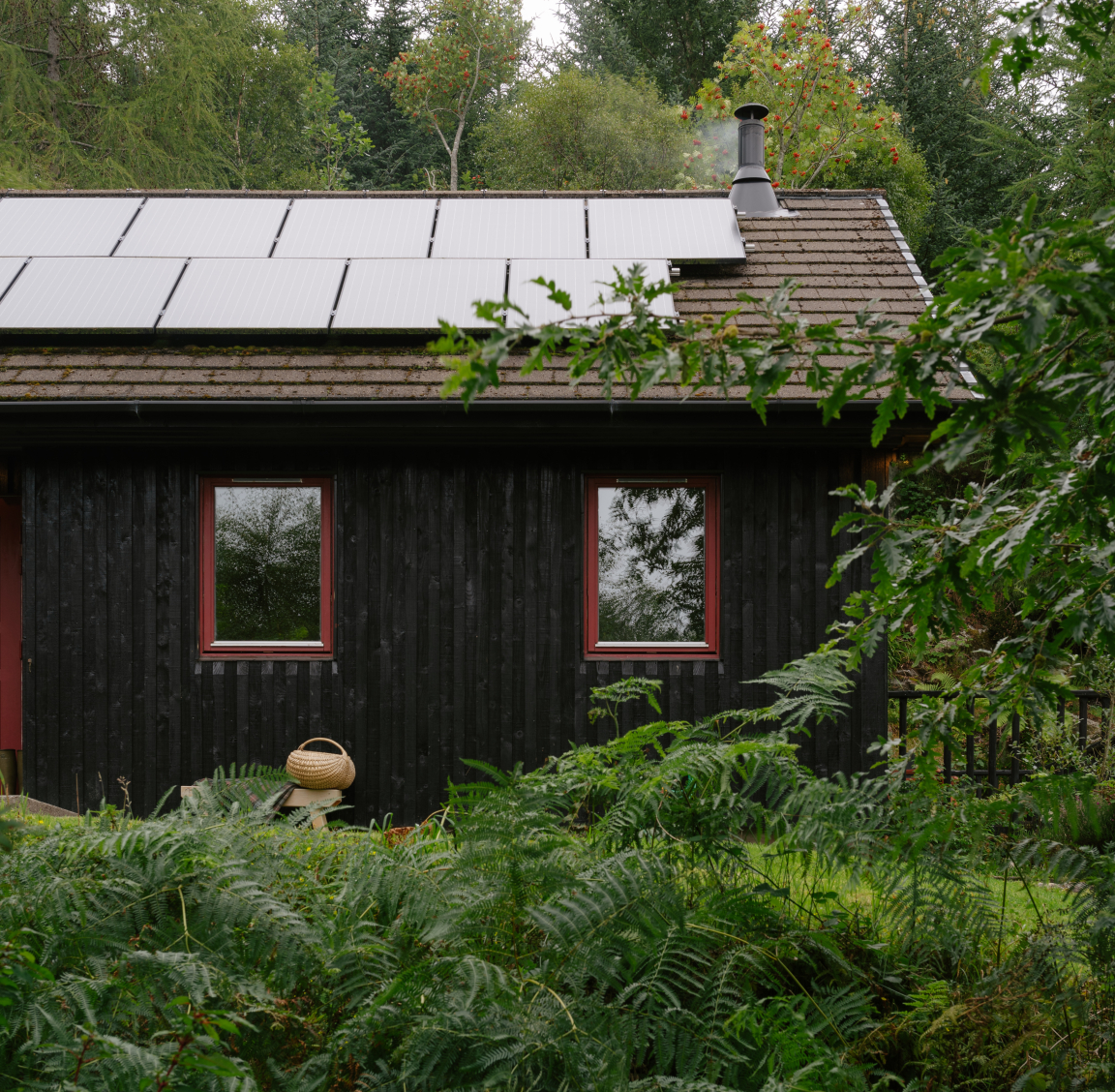 Charming retrofit retreat featuring Swedish architectural timber, solar panels, and surrounded by lush greenery in the West Highlands.