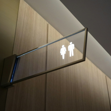 Signage indicating gendered restrooms, highlighting compliance with accessibility and building regulations ahead of Part T implementation.