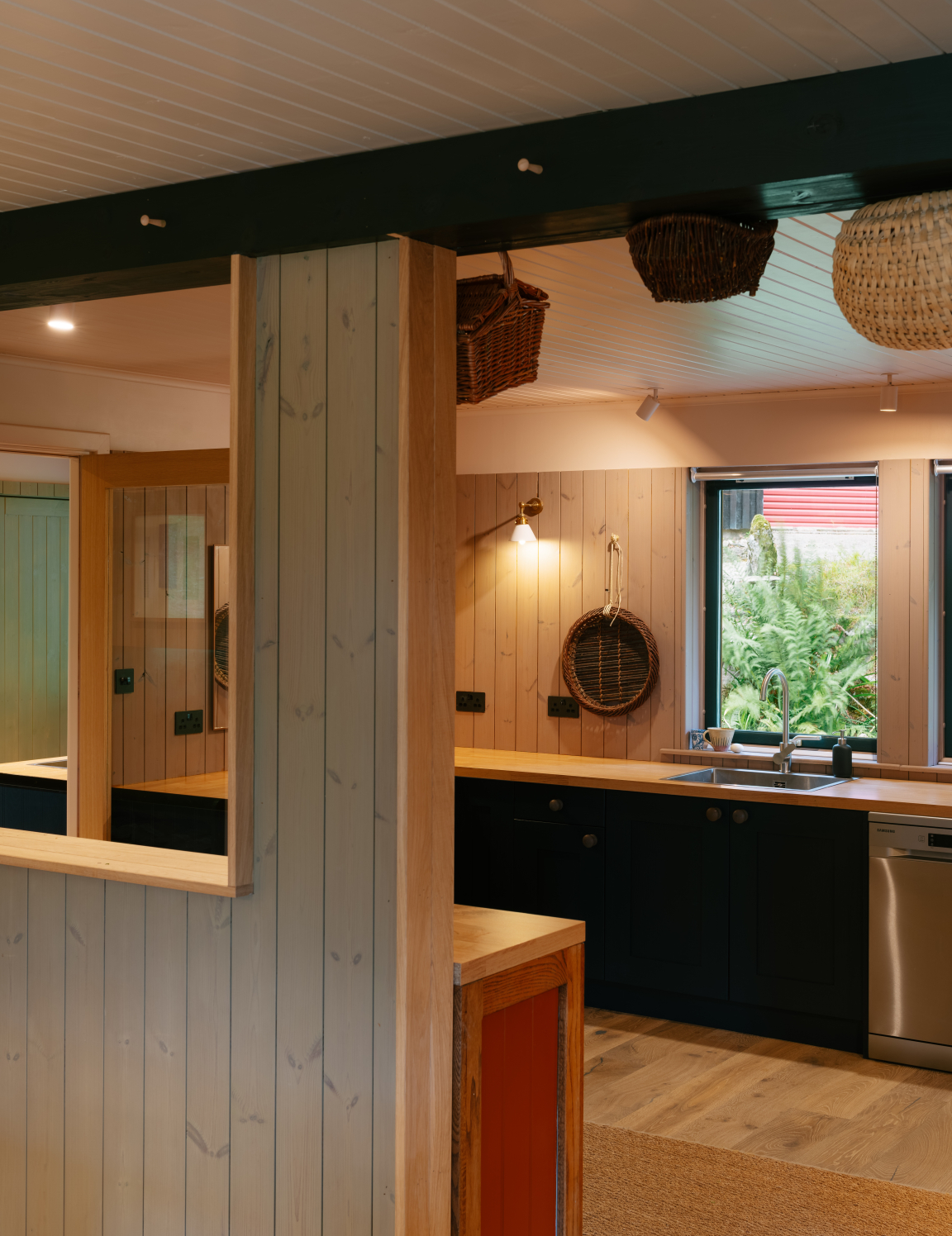 Welcoming kitchen interior featuring natural wood finishes, blending West Highland and Scandinavian design elements in a retrofitted retreat.