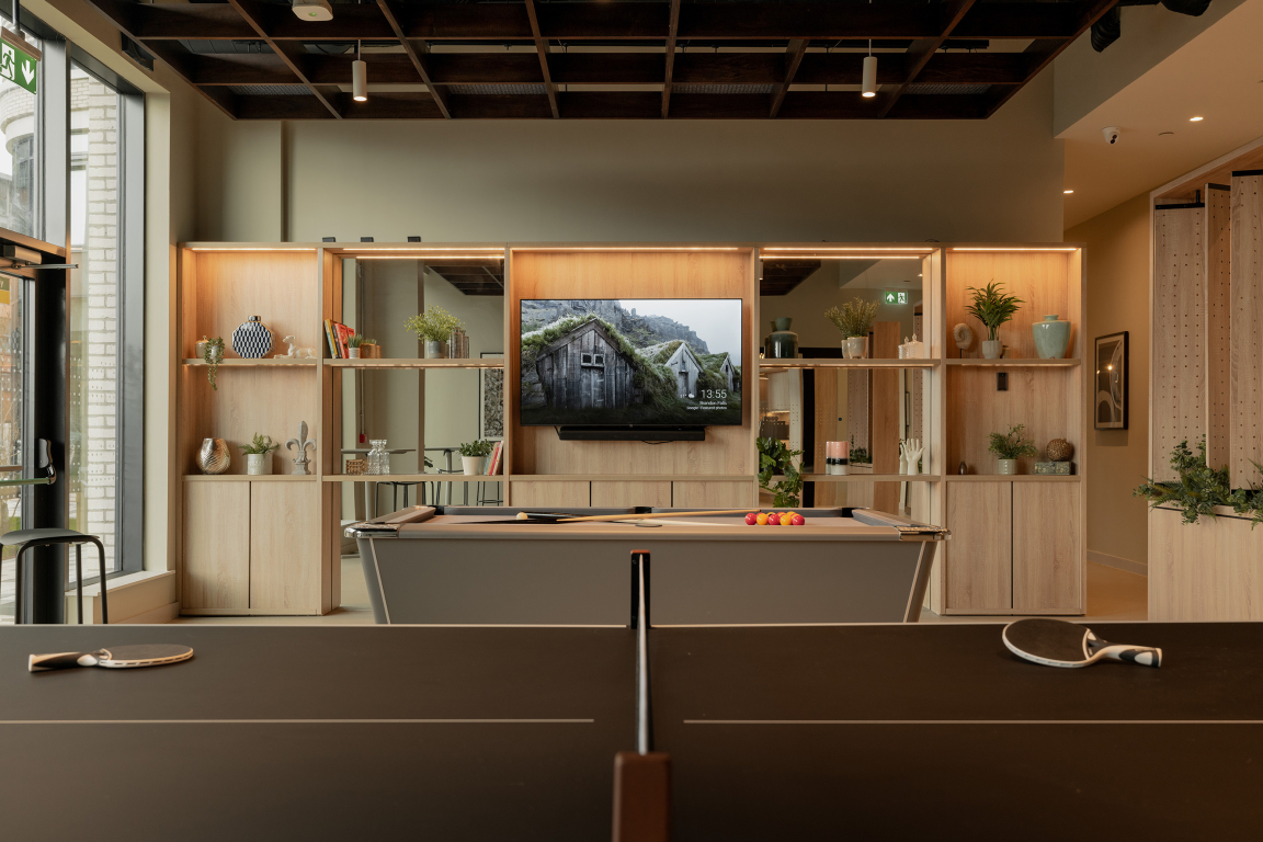 Sophisticated interior of communal space at The Place, Nottingham, featuring a pool table and stylish shelving with decor.