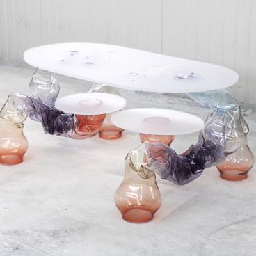 Translucent coffee table with organic shapes and multicolored glass legs, part of Adorno's Matérialité collection from Paris Design Week.