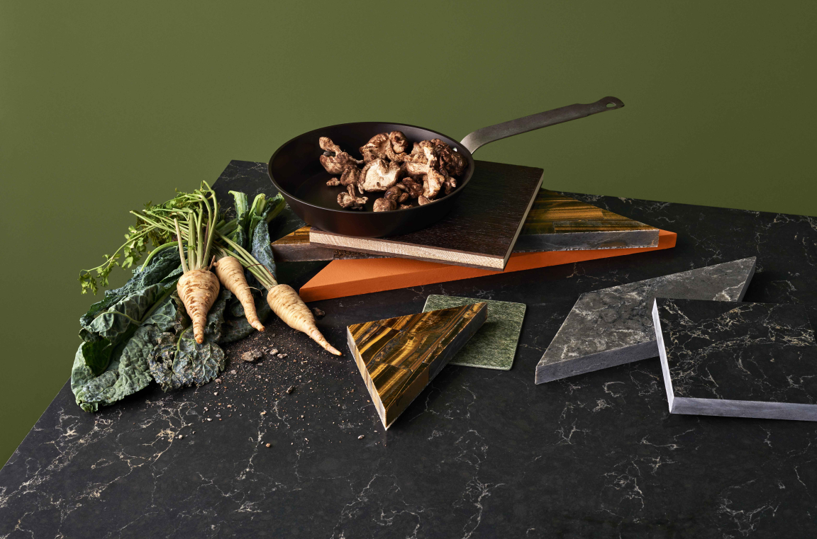 Stylish quartz surfaces with fresh vegetables and a skillet, showcasing modern interior design trends for 2019.