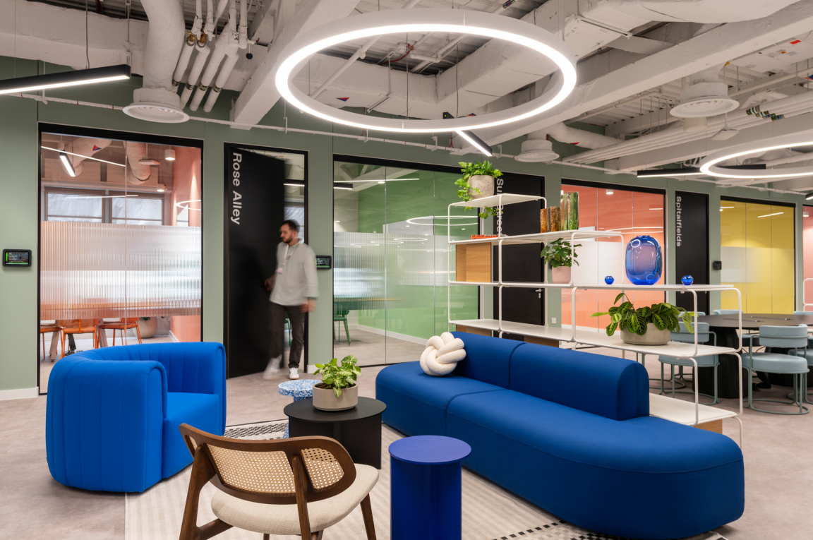 Vibrant coworking space featuring colorful furniture and plants, designed for innovation and collaboration at Huckletree.