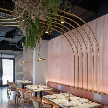 Contemporary interior of Mezza House restaurant in Dubai, featuring elegant furnishings and lush greenery decor.