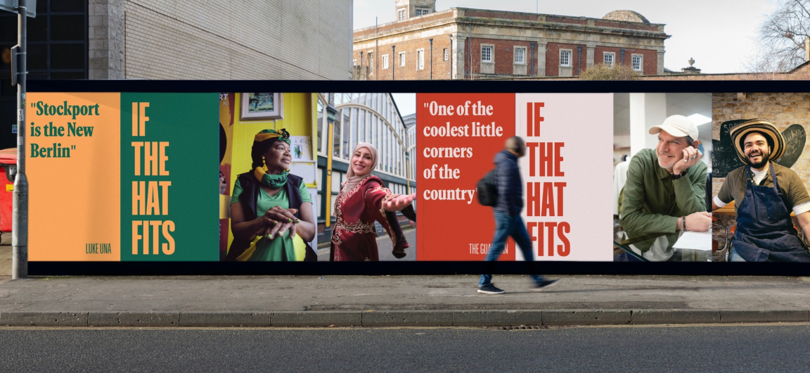 Colorful billboard promoting community pride in Stockport, featuring diverse individuals and the slogan "If the Hat Fits."