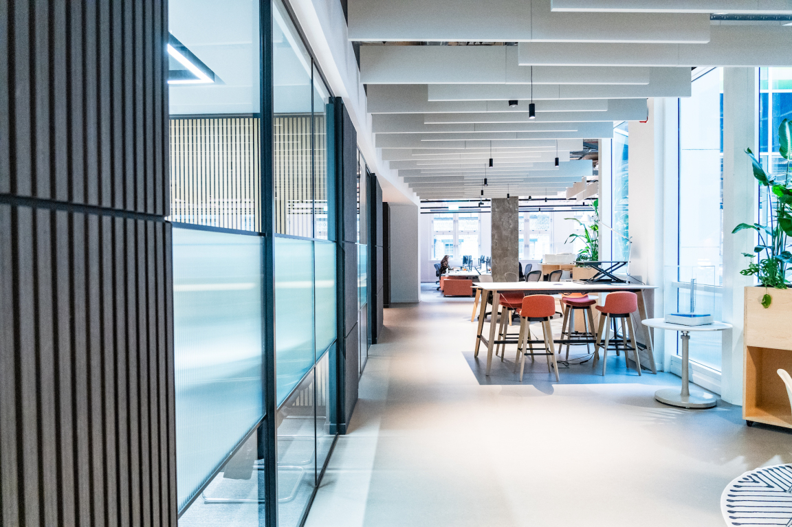 Modern office interior of BDP Glasgow's new studio in the historic Grosvenor Building, featuring open workspace and vibrant furniture.