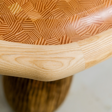 Detailed close-up of a handcrafted wooden table showcasing intricate textures, merging traditional carpentry with modern design by Jan Hendzel.