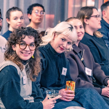 Engaged audience members at a seminar on net zero carbon buildings, demonstrating interest in sustainable architecture practices.